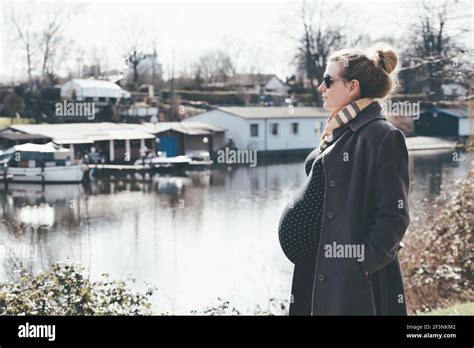 Heavily Pregnant Blonde Woman Taking A Walk By The River Stock Photo Alamy