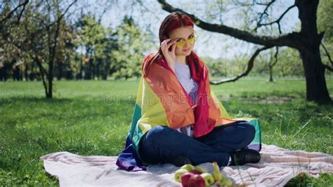 Pretty Woman Lesbian In The Park Posing In Front Of The Camera While Holding The Rainbow Lgbt