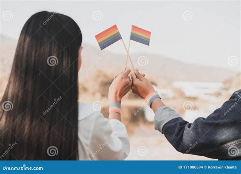 Cropped Shot Of Lgbt Lesbian Couple Hands Holding A Rainbow Pride Flag At Sunset Lgbt Rights