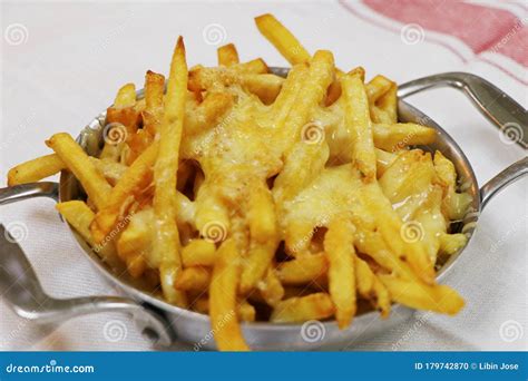 Golden Fried French Fries With Melted Cheddar Cheese Known As Cheesy