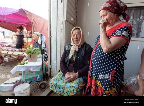Old Russian Babushka grandmother sitting down and selling her produce ...