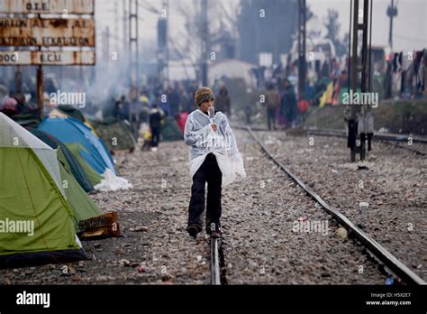 A Syrian Refugee Boy Walks Next To The Raiway Tracks Inside The