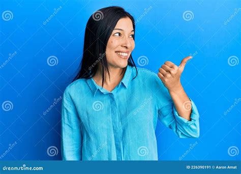 Joven Latina Con Ropa Casual Apuntando El Pulgar Hacia El Lado Sonriente Feliz Con La Boca