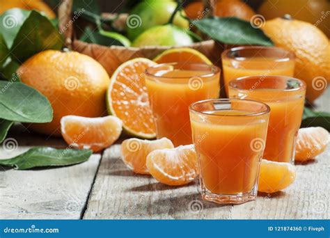 Fresh Tangerine Juice With Slices Of Mandarin On Old Wooden Back Stock