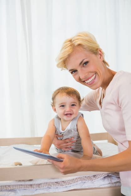 Premium Photo Portrait Smiling Of Blonde With His Son Using Digital Tablet