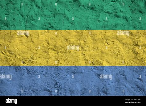 Gabon Flag Depicted In Bright Paint Colors On Old Relief Plastering