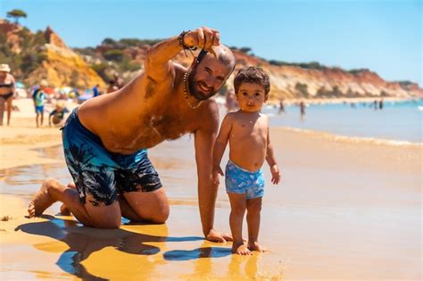 Premium Photo Father Playing In The Sand With Son Praia Do Barranco