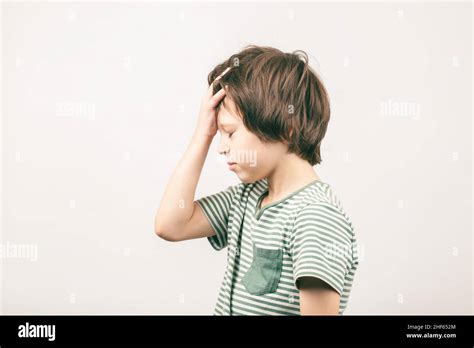 Disappointed Little School Age Boy Placing Hand On Head Face Palm