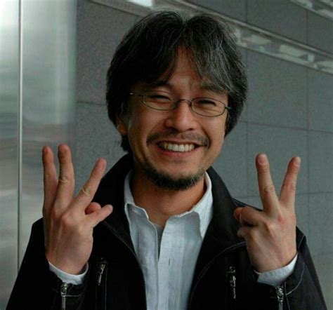 a man with glasses making the peace sign