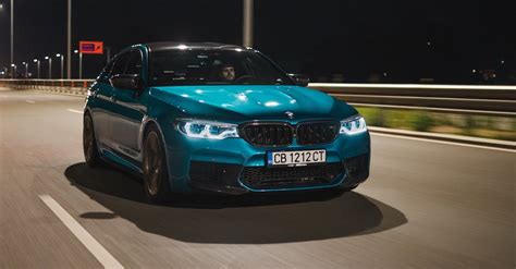 Man Driving a Blue BMW M5 on a Street · Free Stock Photo