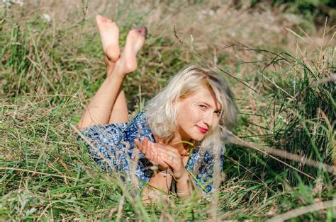 Blonde Woman Lying In Grass Looking At Camera Stock Photo Image Of Looking Comfort 293399178