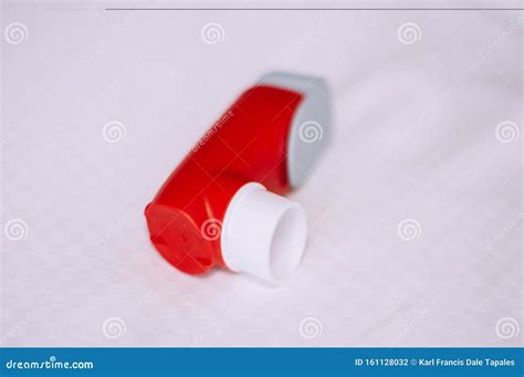 A Still Life of Red and White Asthma Inhaler Devise on a White ...