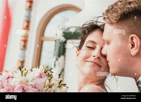 Beautiful Bride And Groom Hugging And Kissing On Their Wedding Day