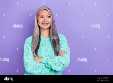 Photo Of Cheerful Mature Lady Curious Look Empty Space Clever Imagination Isolated Over Violet