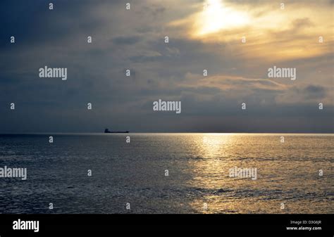 Boat on the Horizon Stock Photo - Alamy