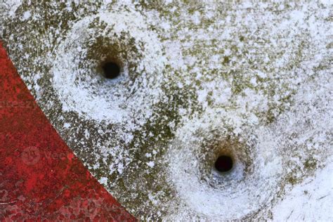 Detailed Close Up Of Bullet Holes From Gun Shots In A Traffic Sign