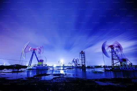 Oil Field Site In The Evening Oil Pumps Are Running Photo Sunset