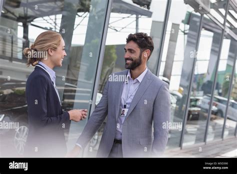 car sales people talking  car dealership showroom stock photo