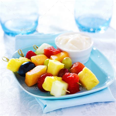 children's fruit kabob with vanilla yogurt dip on blue plate Stock ...