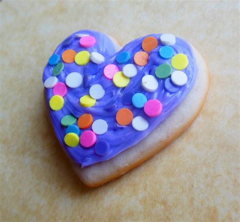 purple frosting with sprinkles sugar cookie by ScrumptiousDoodle