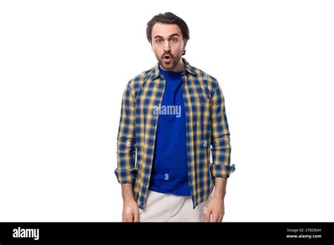 Well Groomed Brunette Brutal Man With A Beard In A Plaid Shirt On A White Background With Copy