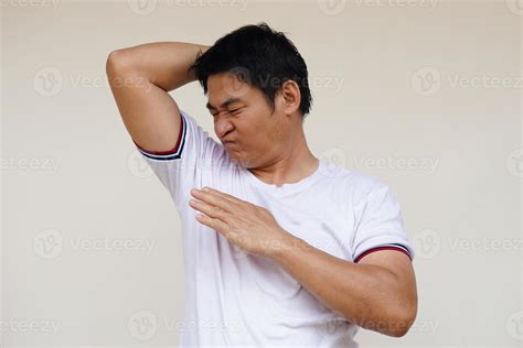 Asian Man Checks His Body Odor During He Feels Hot Raises Right Arm Up Smells His Armpit