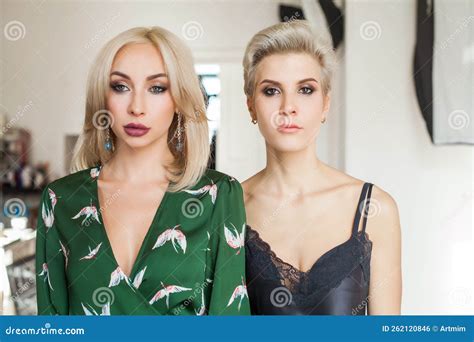 Two Beautiful Blonde Women In Nice Gowns Are Standing Together Stock Photo Image Of Beauty