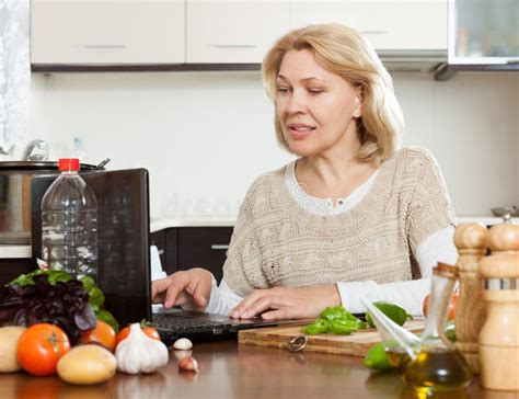 Mature Woman Cooking With Notebook Stock Image Image Of Looking Senior