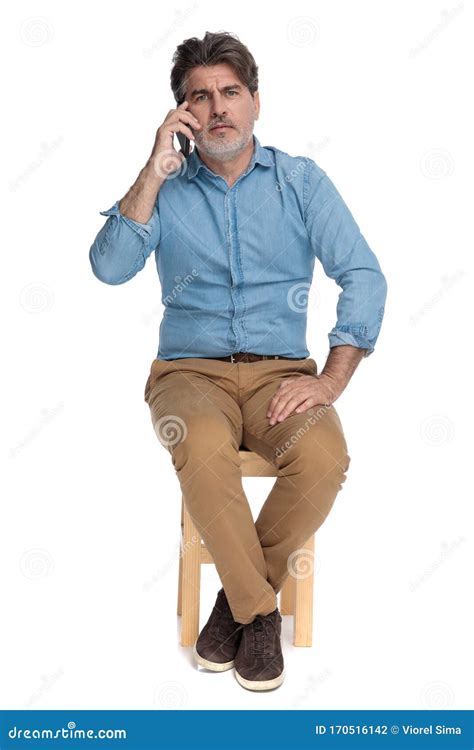 Upset Casual Man Talking On His Phone And Frowning Stock Photo Image