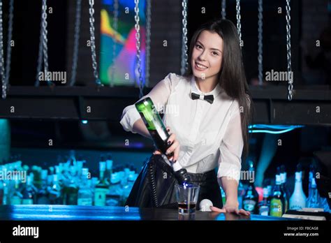 Beautiful Cheerful Brunette Bartender Girl In White Shirt And Black Bow Tie Serving Alcohol