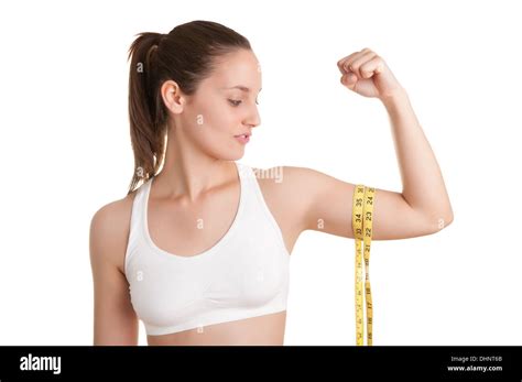 Powerful Woman Measuring Her Biceps With A Yellow Measuring Tape Stock