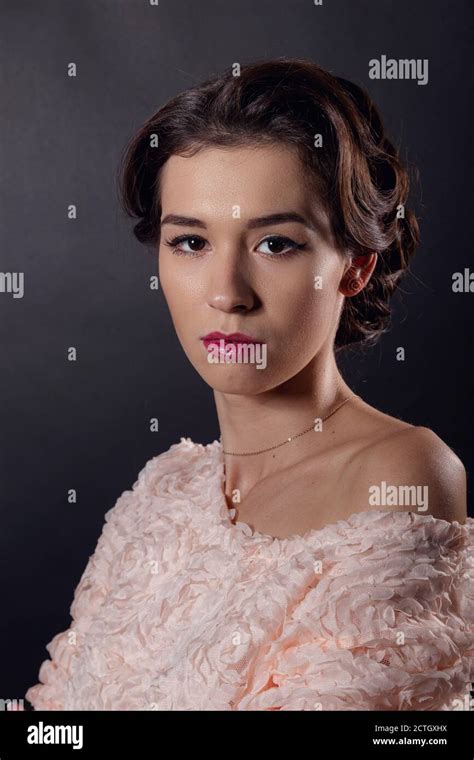 Tender Portrait Of A Mysterious Brunette With Neat Makeup And In A Pink