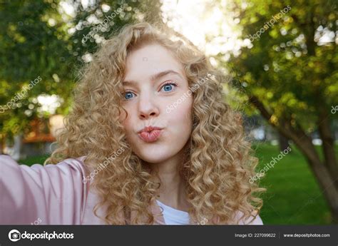 Girl With Brown Curly Hair And Blue Eyes