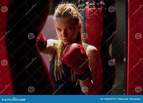 Blonde Caucasian Fighter Girl In Red Boxing Gloves Is Posing On Fight