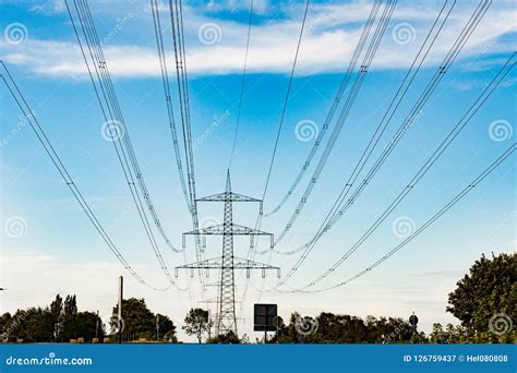 High Tension Power Line In Blue Sky With Clouds Transmission Lines