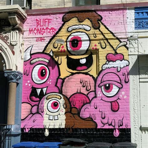 Graffiti Painted On The Side Of A Building With Pink Eyes And Two