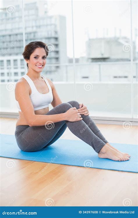 Sporty Smiling Brunette Sitting On Exercise Mat Stock Photo Image Of