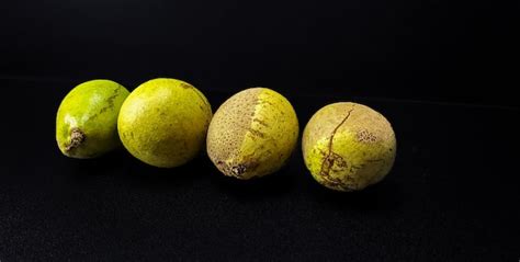 Premium Photo Four Ripe Matoa Fruits On A Black Background