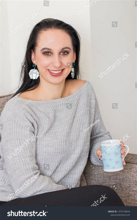Smiling Brunette Sitting On Chair Holding Stock Photo Shutterstock