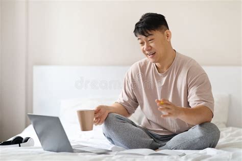 Mature Man Sitting On Bed Using Laptop Have Video Chat Stock Photo Image Of Comfortable