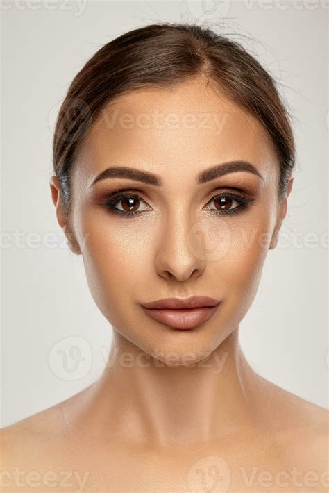 Close Up Portrait Of A Brunette Nude Model Girl With Professional Evening Make Up And Plump Lips