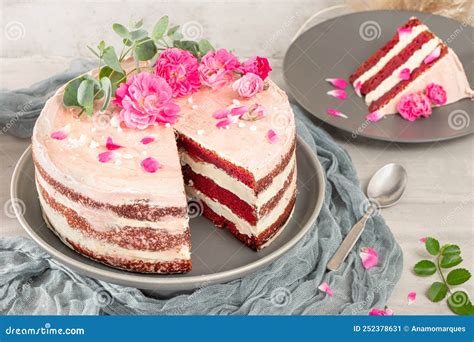 Red Velvet Naked Cake With Fresh Roses And Swiss Buttercream On Kitchen Countertop Stock Image