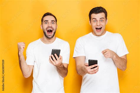 Two cheerful excited men friends wearing blank t-shirts Stock Photo ...