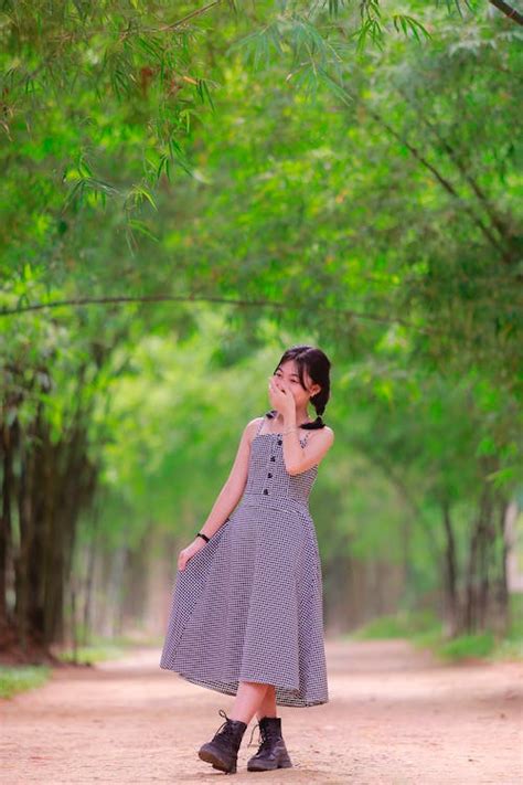 Girl in a Dress Posing in a Park · Free Stock Photo