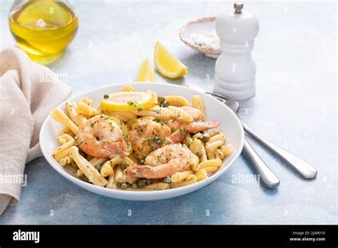 Lemon shrimp piccatta with penne, lemons and capers Stock Photo - Alamy