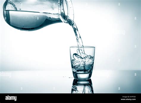 Pouring Water From Pitcher Into A Glass Stock Photo Alamy