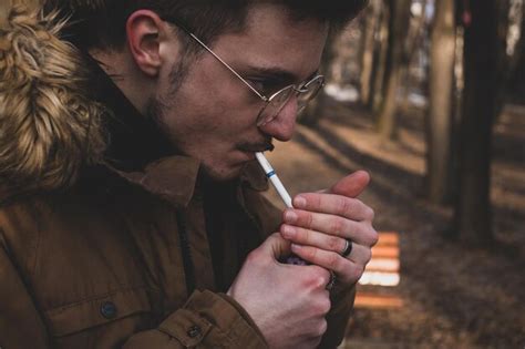 Premium Photo Close Up Side View Of Man Smoking Cigarette In Forest