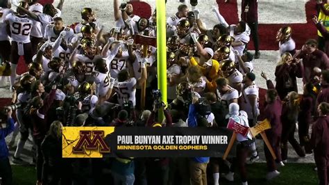 Minnesota Celebrates With The Paul Bunyan Axe Trophy After Beating