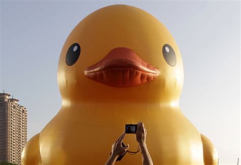 A man takes a picture of the “Rubber Duck” by Dutch conceptual artist ...