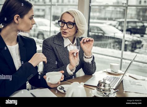 Blonde Haired Businesswoman Giving Some Instructions To Her Trainee Stock Photo Alamy